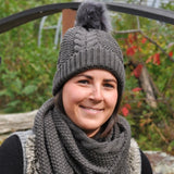Toque with cables and pompom